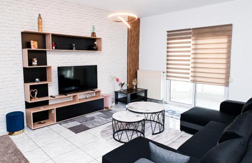 a living room with a couch and a tv at Central appartment in Alexandroupoli