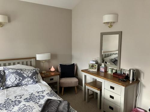 a bedroom with a bed and a desk with a mirror at Sixteen B in York