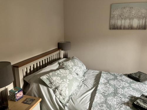 a bedroom with a bed with a pillow and a table at Sixteen B in York