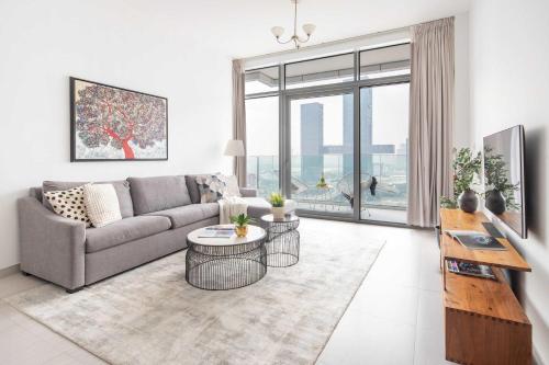 a living room with a couch and a table at Frank Porter - Park Gate in Dubai