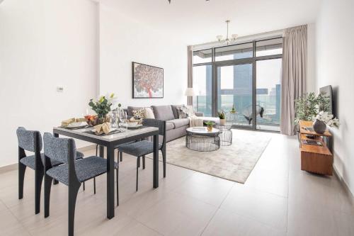 a living room with a table and chairs and a couch at Frank Porter - Park Gate in Dubai