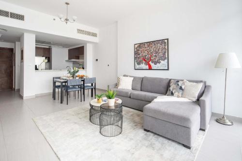 a living room with a couch and a table at Frank Porter - Park Gate in Dubai