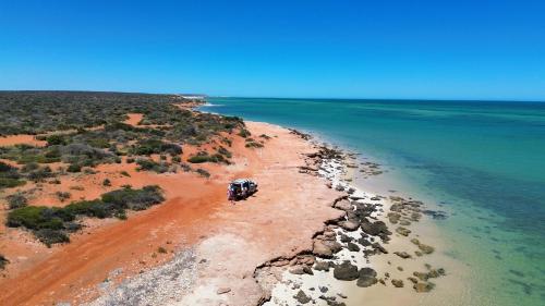 an aerial view of a beach with a vehicle on it at Wildsights Beach Units in Denham