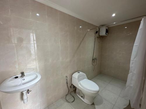 a bathroom with a toilet and a sink at Lajimbar Villa in Ketewel