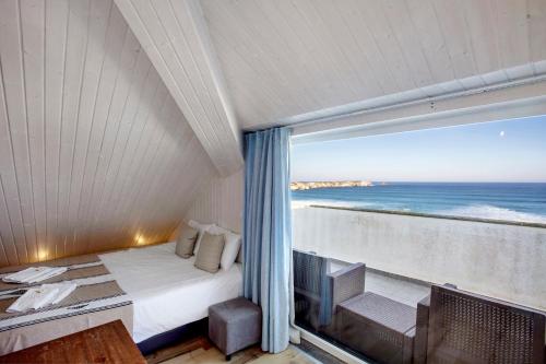 a bedroom with a bed and a view of the ocean at Surfcastle bnb and Surf School in Ferrel