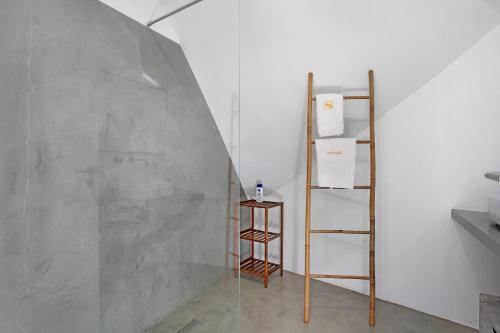 a room with a wall with a ladder and a shelf at Surfcastle bnb and Surf School in Ferrel