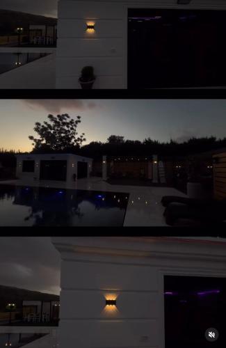 a night view of a house with a light at לוסטלה ווילה in Ein Kinya