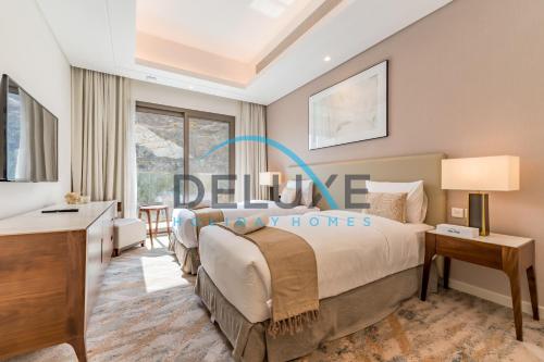 a bedroom with a large bed and a window at Limited Offer 4BR plus Maid's Villa Close to Beach by Deluxe Holiday Homes in Fujairah