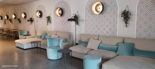 a living room with couches and tables and mirrors at Best Western Hotel Massafra in Massafra