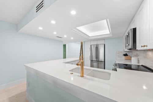 a kitchen with a white counter top and a sink at Sanddollar #A202 in Ybel