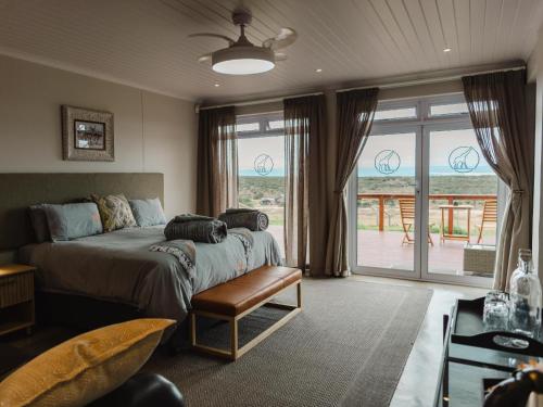 a bedroom with a bed and a large window at Longhill Reserve in Addo
