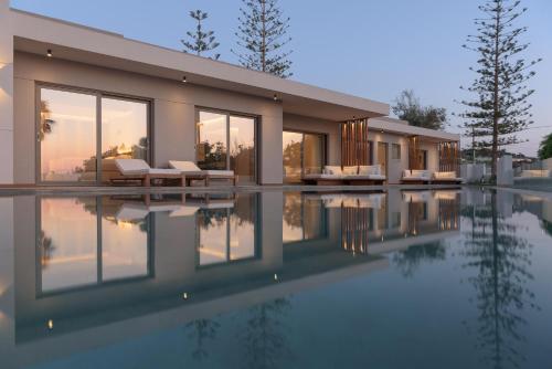 a house with a pool in front of it at Marae Villa in Skaleta