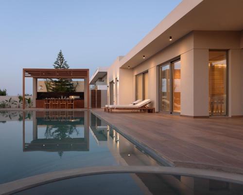 a villa with a swimming pool and a house at Marae Villa in Skaleta