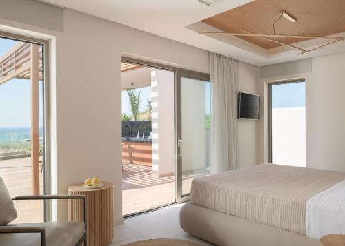 a bedroom with a bed and a balcony at Marae Villa in Skaleta