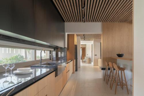a kitchen with a counter and some stools in it at Marae Villa in Skaleta