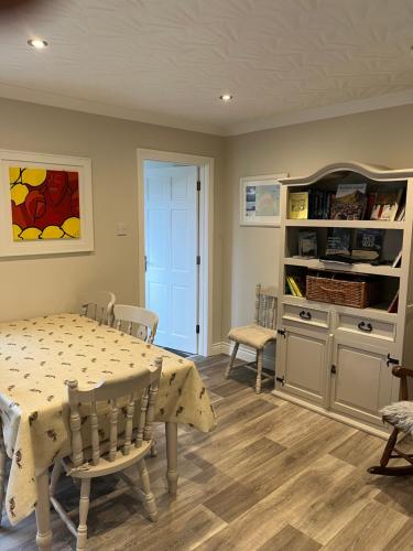 a dining room with a table and chairs at Ballycastle Best Times in Ballycastle
