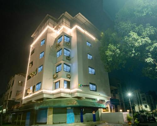a tall building with lights on it at night at Treebo Shembekars Inn in Nagpur