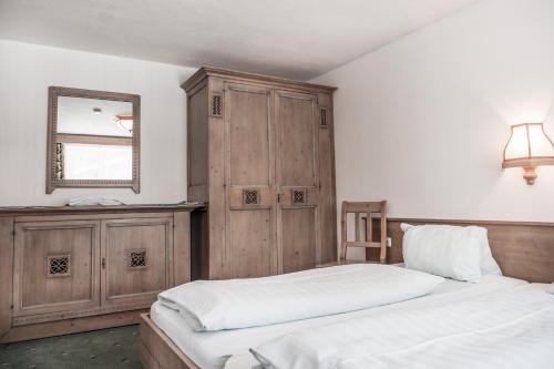 a bedroom with two beds and a mirror on the wall at Ferienhaus Rehhaus in Holzgau