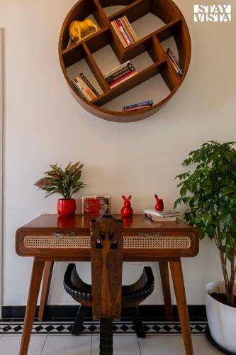 a wooden table with a mirror on a wall at StayVista at Casa PuMa with Pool & WiFi in Camorlim
