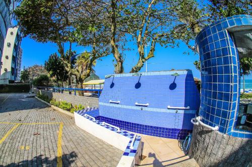 a blue toilet sitting on the side of a street at 13-A - Apto 2 dorms c/ar condicionado + 1vaga in Guarujá
