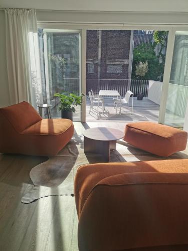 a living room with two chairs and a table at Living Gent in Ghent