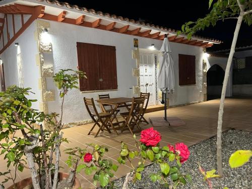 a patio with a table and chairs and an umbrella at Ca La Lola in Llorenç del Penedes