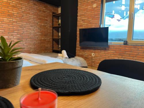 a round black mat on top of a wooden table at Mickitos Apartments - Mavrovo in Mavrovo