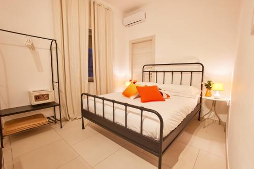 a bedroom with a bed with orange pillows on it at Villa Vera in Salerno