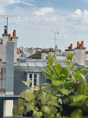a view of a city from a roof at Hotel Des Deux Continents in Paris