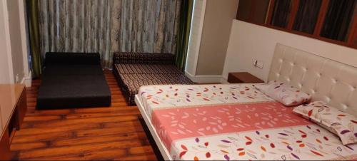 a small room with two beds and a couch at Teghs Hospitality - Entire Superior Villa Bungalow in Chandīgarh