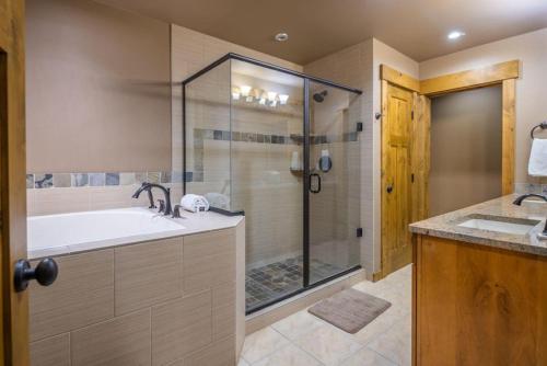 a bathroom with a shower and a sink and a tub at Suncadia Trailhead 1 Condo 208 in Cle Elum