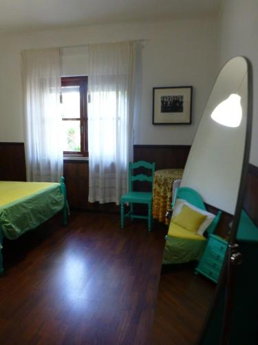 a room with a bed and a surfboard in it at Casa Tangerina in Tavira