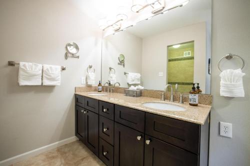 a bathroom with a sink and a large mirror at Scottsdale Miller in Scottsdale