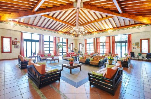 a large living room with couches and tables at PortAventura Hotel El Paso - Includes PortAventura Park Tickets in Salou