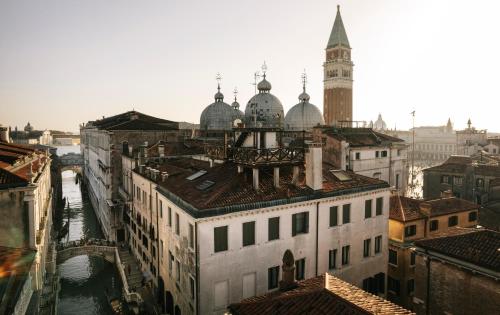 an aerial view of a city with a clock tower at Hotel Al Ponte Dei Sospiri in Venice