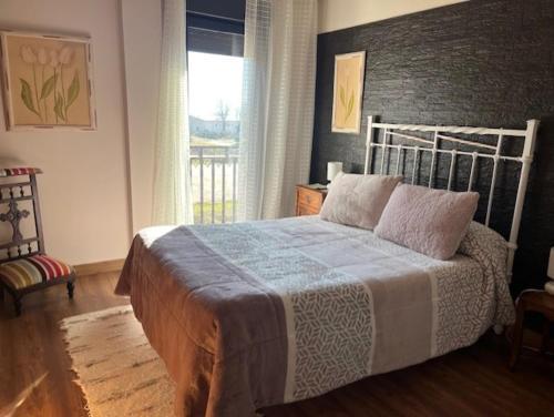 a bedroom with a bed and a window at Rosancha in Lagunilla