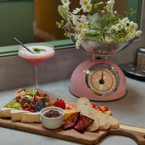 a tray of food with bread and a drink and a clock at Estate Of Ord in Muir of Ord