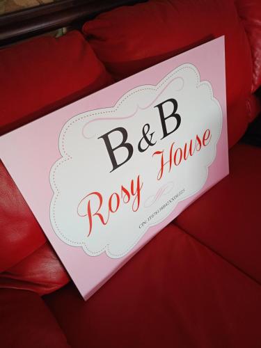 a sign that reads bestory house is held in a hand at rosy house in Scalea