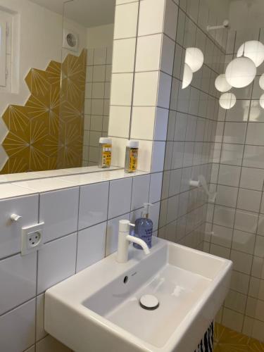 a bathroom with a white sink and a mirror at Sølyst in Silkeborg