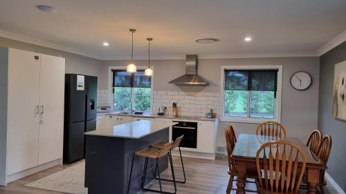 a kitchen with a counter and a table and chairs at Fig Tree Farm B&B Highvale-Farmstay near Brisbane! in Highvale