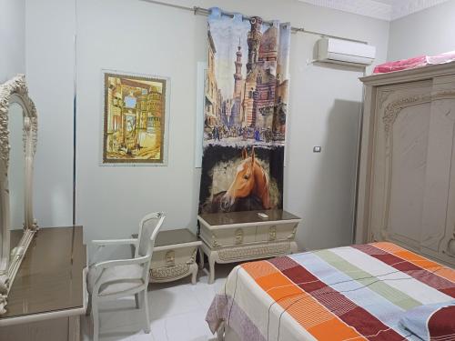 a bedroom with a bed and a horse painting on the wall at Villa Carimo in Quseir