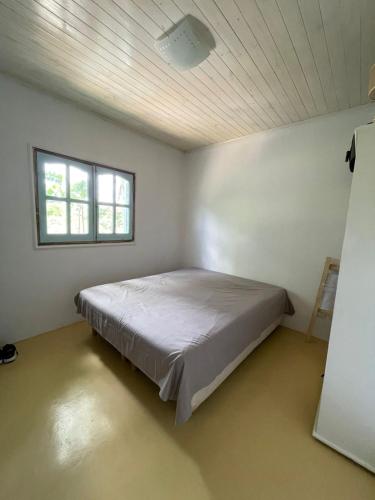 a bedroom with a bed in a white room at Casa en el Quebrachito in Formosa