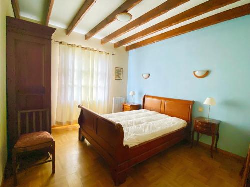 a bedroom with a bed in a room with blue walls at St Josse Farmhouse - Nr Le Touquet in Saint-Josse