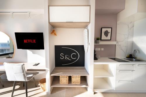 a kitchen with a desk and a chalkboard on the wall at Sea & the City in Thessaloniki