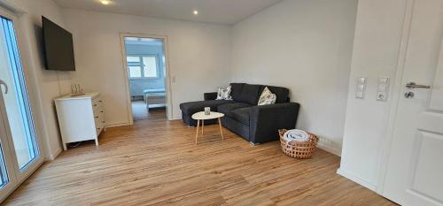 a living room with a couch and a table at Ferienwohnung Schuller in Gottmadingen