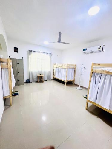a large room with a room with beds in it at Sukoon Hostel in Muscat