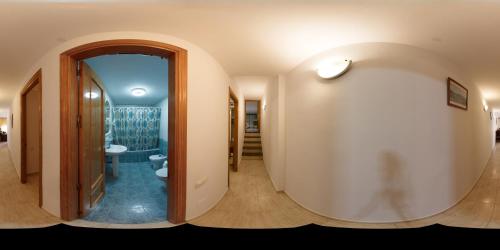 een hal met een badkamer met een toilet en een spiegel bij Apartamentos Manbea in San José