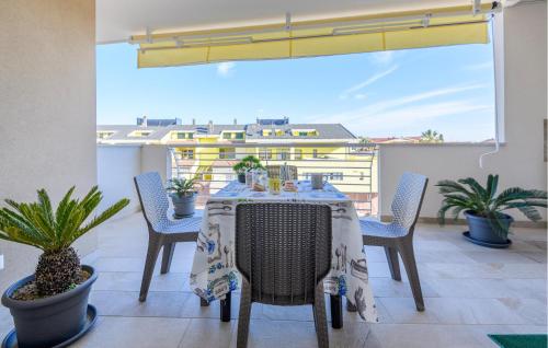 a table and chairs on a balcony with plants at Cozy Apartment In Tortoreto Lido in Tortoreto Lido