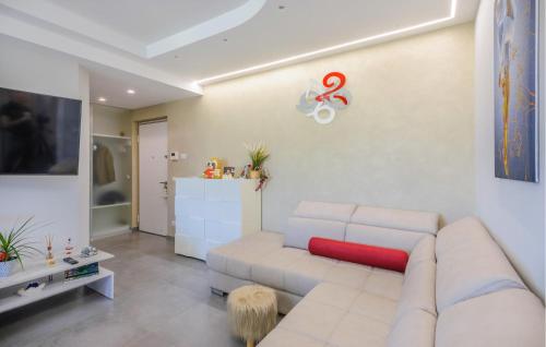 a living room with a white couch and a table at Cozy Apartment In Tortoreto Lido in Tortoreto Lido
