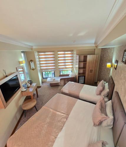 a hotel room with two beds and a television at Sultan Hamit Hotel in Istanbul